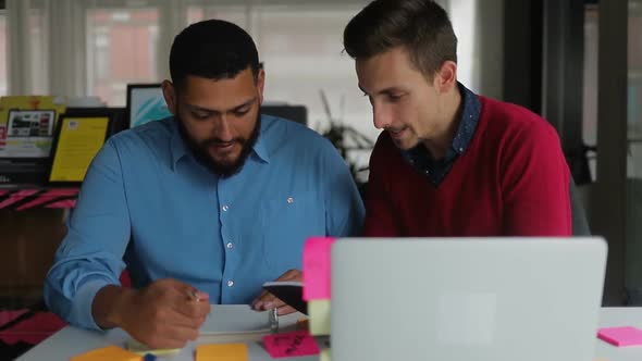 Confident Young People Working Together in Office