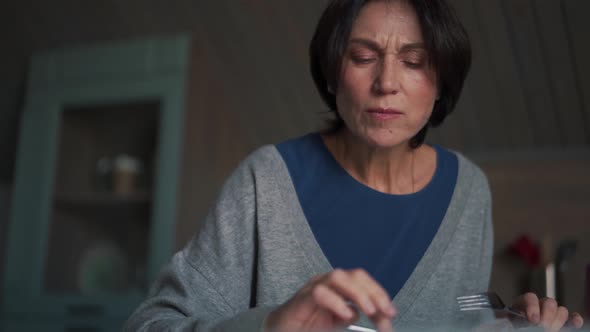 Surprised woman eating food and looking at phone