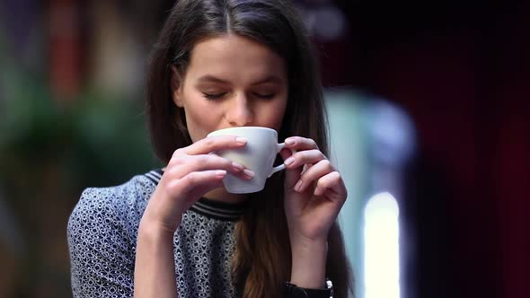 Beautiful Woman Drinking Coffee At Cafe