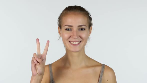 Sign of Winner, Portrait of Victorious Beautiful Girl, White Background