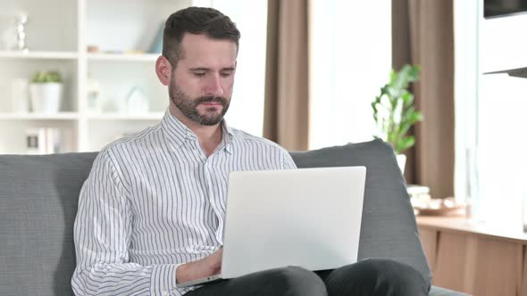 Professional Young Businessman Working on Laptop at Home 