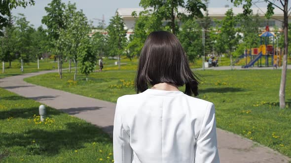 Stylish Woman Walking on Path in Park