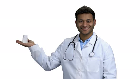 Male Doctor Showing Pills on White Background