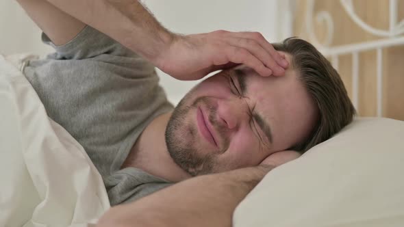 Portrait of Beard Young Man Having Headache in Bed