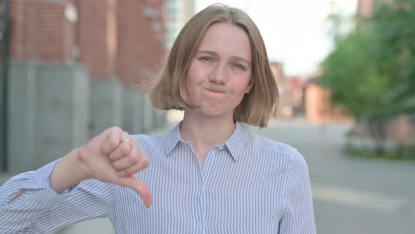 Portrait of Woman Showing Thumbs Down Gesture Outdoor