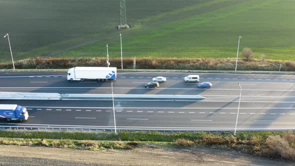 Aerial Shot of Highway with Cars During Sunny Day - Side Shot