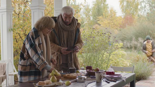 Boy Having Outdoor Lunch with Grandparents