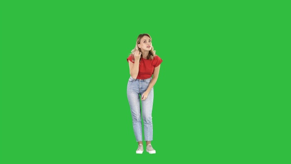 Woman in front of a mirror preening on a Green Screen, Chroma Key.