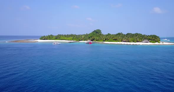 Luxury fly over island view of a sandy white paradise beach and blue sea background in high resoluti