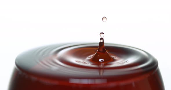 900083 Drop of Red Wine being poured into Glass, against White Background, Slow motion 4K