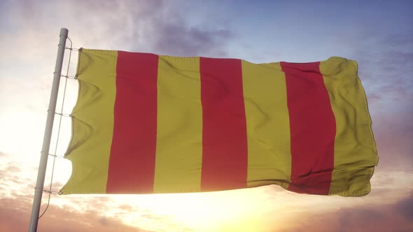 County of Foix flag, France, waving in the wind, sky and sun background