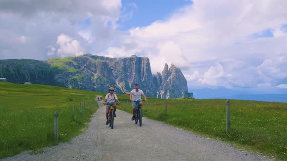 Couple Men and Woman on Vacation in the Dolomites ItalyAlpe Di Siusi  Seiser Alm South Tyrol Italy