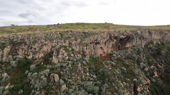 FPV Racing Drone Mountain Surfing and Cliff Diving Along the Rocks