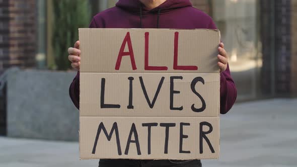 ALL LIVES MATTER on a Cardboard Poster in the Hands of Male Protester Activist. Closeup of Poster