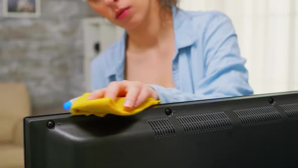 Woman Wiping Dust From the TV