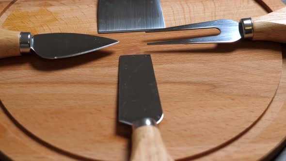 Cheese Knifes and Fork on Wooden Platter