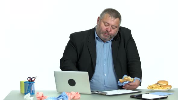Busy Businessman Talking on Phone and Eating Burger