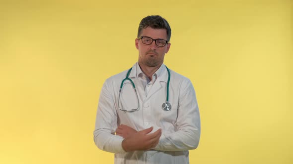 Good-looking Young Doctor in Lab Coat Showing That He Can't Help in This Situation and Spreading