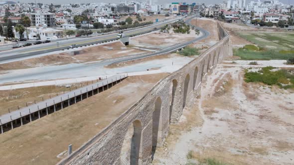 Drone shot orbiting around the Kamares Aqueduct arches of Larnaca