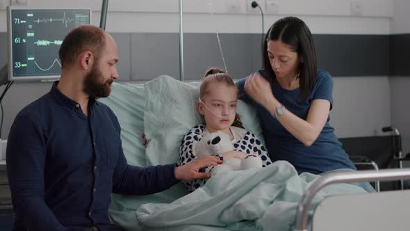 Sick Daughter with Oxygen Nasal Tube Resting in Bed After Suffering Sickness Infection Surgery