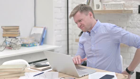 Businessman Having Back Pain While Working