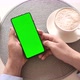 Man holding smartphone with vertical green screen and touch on screen. - VideoHive Item for Sale