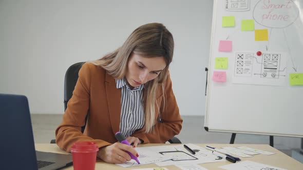 Woman Creating New Prototype for Mobile Application on Paper