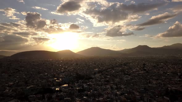 Cloudy aerial drone shot in sunset, Mexico city