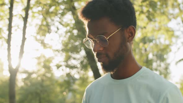 Portrait of Young Afro-American Man Outdoors on Sunny Day