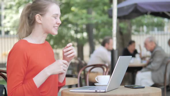 Online Video Chat By Young Woman Sitting in Cafe Terrace