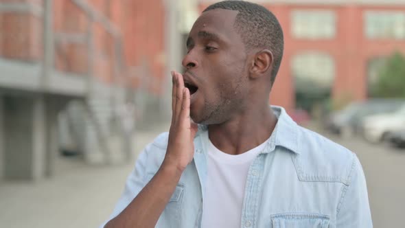 Outdoor Portrait of African Man Yawning