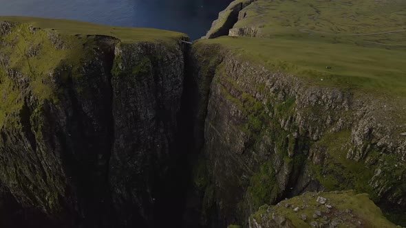 Drone Flight Descending Over Cliff Edges On Coastline