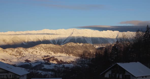 Snow-Covered Mountains With Blue Sky At Sunrise - Wide Shot