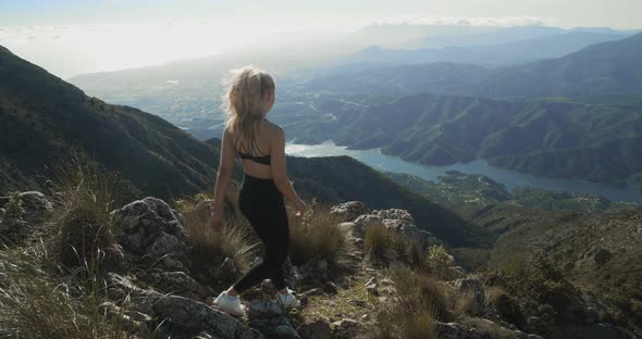 Blond Woman In Sportswear Walking In La Concha Landscape