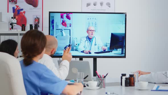 Concentrated Purposeful Experienced Medical Team Holding Online Video Meeting