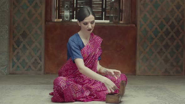 Elegant Indian Style Woman Putting Bracelets on