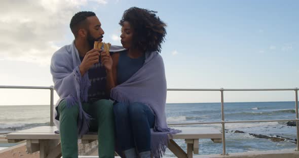 Couple eating ice cream cone at beach 4k