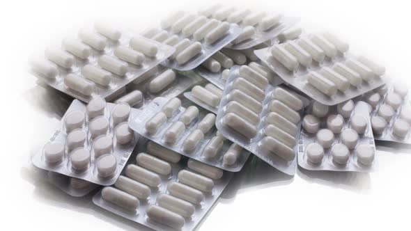 Closeup Shot of Different Pills Falling on Table with Tablets , Pharmaceutical