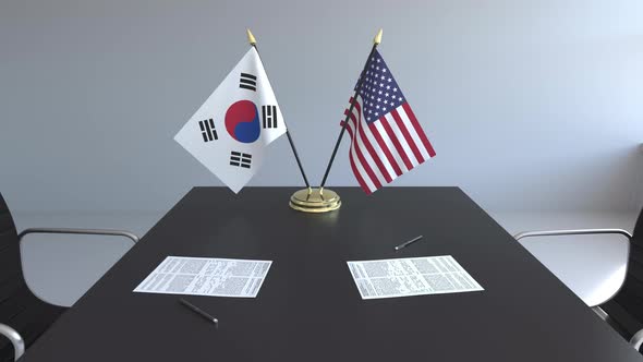 Flags of South Korea and the USA and Papers on the Table alt