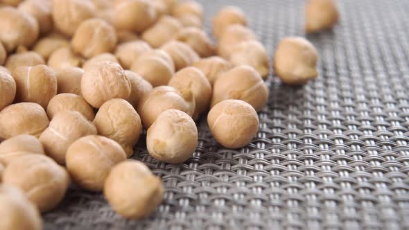 Raw dried chickpeas on a plastic kitchen mat