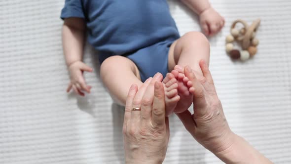 Gymnastics Exercises Stretching Baby's Legs and Feet Infant Massage