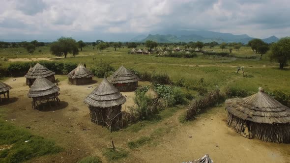 Aerial above an authentic Village With homes made from wood and straw in Uganda, East Africa