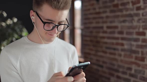 Young Boy Texting on His Smartphone 