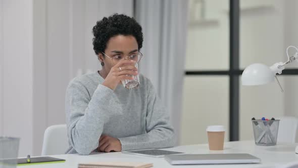 African Woman Drinking Water at Work