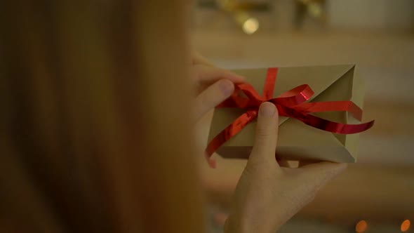 Slowmotion Shot of a Young Woman Preparing a Christmas Edvent Calendar