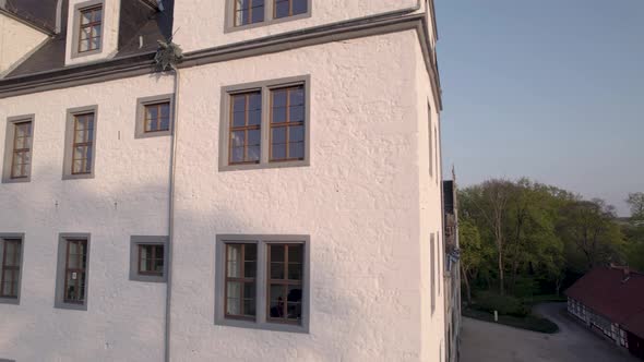 Closeup of Wolfsburg Castle wall, rotating to reveal whole castle during sunset