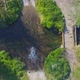 Mountain biker riding through river, aerial top down view of adventure - VideoHive Item for Sale