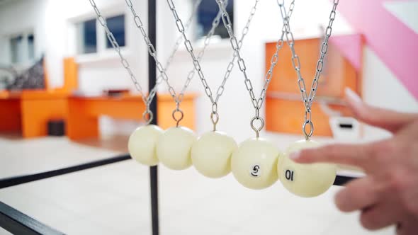 Newton's cradle showing laws of physics in motion. Museum of Science and newton pendulum