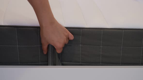 Woman is Choosing New Mattress for Good Sleeping