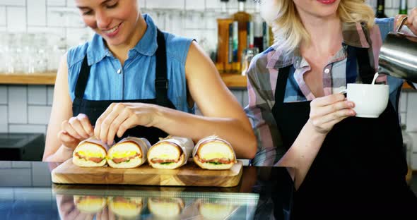 Two beautiful waitress working behind the counter